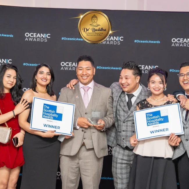 Dé Buddha team receiving the “Best Dining Experience” award on stage.
